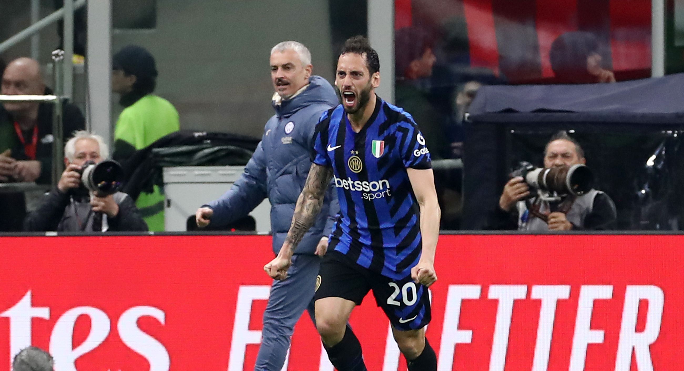 Hakan Calhanoglu celebrates scoring for Inter against Milan